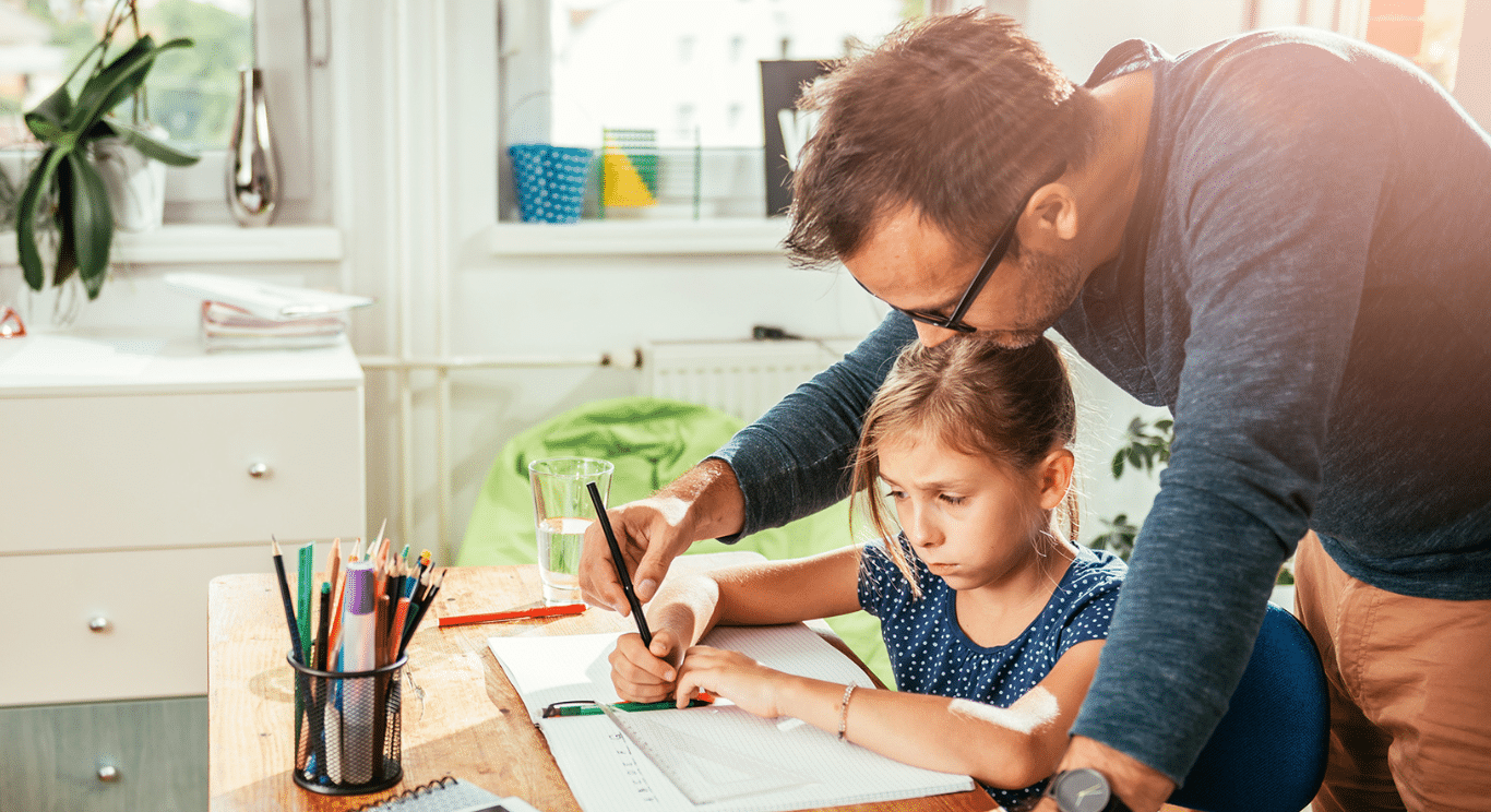 Father helping daughter with schoolwork